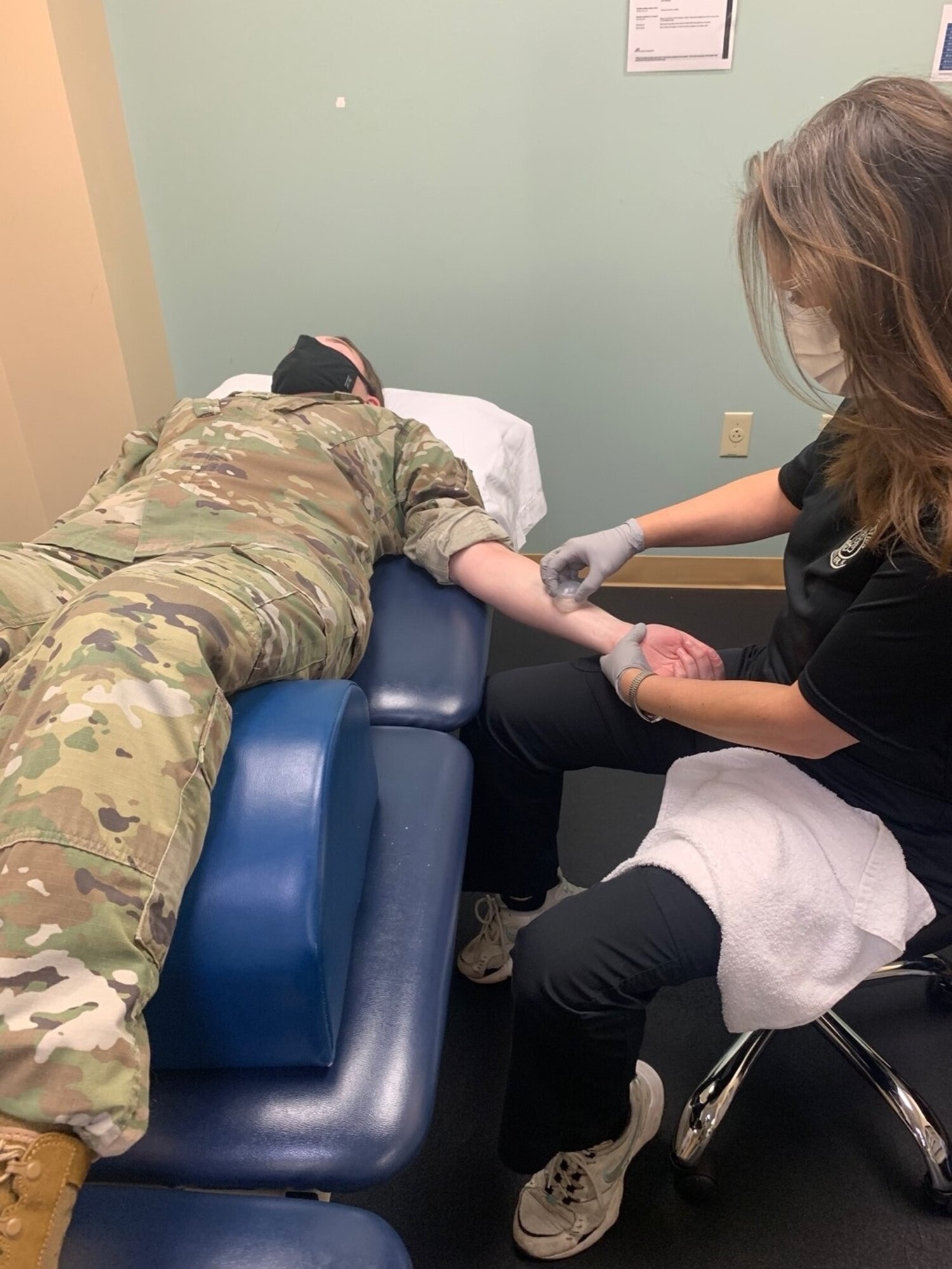 Juliet Phaneuf, 6th Operational Medical Readiness Squadron physical therapy assistant, conducts dynamic cupping techniques on a patient to decrease pain at MacDill Air Force Base, Florida, Oct. 26, 2021. The physical therapy clinic staff are experts in helping patients establish goals, improve biomechanics, provide individualized fitness programs, as well as provide education on various aspects of injury prevention to include healing progression and lifestyle modifications, such as sleeping positions, ergonomics and posture. (U.S. Air Force photo)