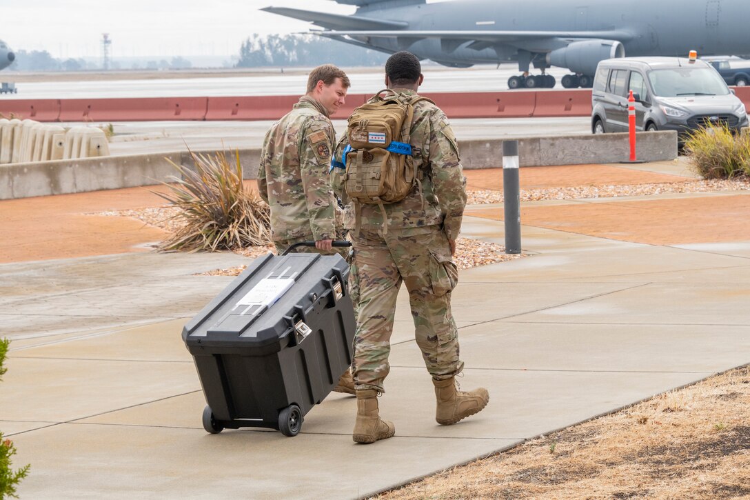 U.S. Air Force  personnel assigned to the 60th Air Mobility Wing relocate operations to an alternate location during a simulated earthquake response Oct. 21, 2021, at Travis Air Force Base, California. Several units at Travis AFB worked together to practice and improve catastrophic incident response skills during the Great Shake Out earthquake exercise. (U.S. Air Force photo by Heide Couch)