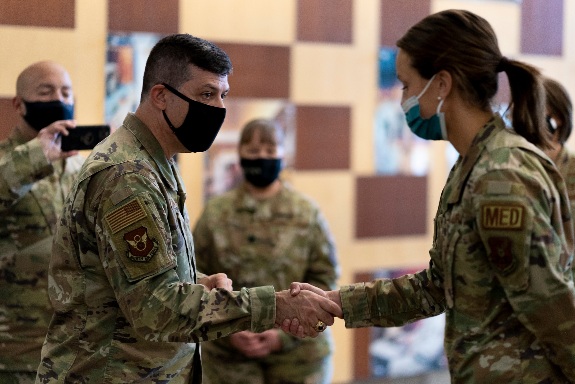 Maj. Gen. Andrew Gebara, 8th Air Force and Joint-Global Strike Operations Center commander, presents a coin to Capt. Kara Christensen, 28th Health Care Operations Squadron family nurse practitioner, at Ellsworth Air Force Base, S.D., Oct. 25, 2021.  Gebara visited Ellsworth AFB and met with 28th Bomb Wing Airmen to see how they are contributing to the Air Force Global Strike Command mission. (U.S. Air Force photo by Senior Airman Austin McIntosh)