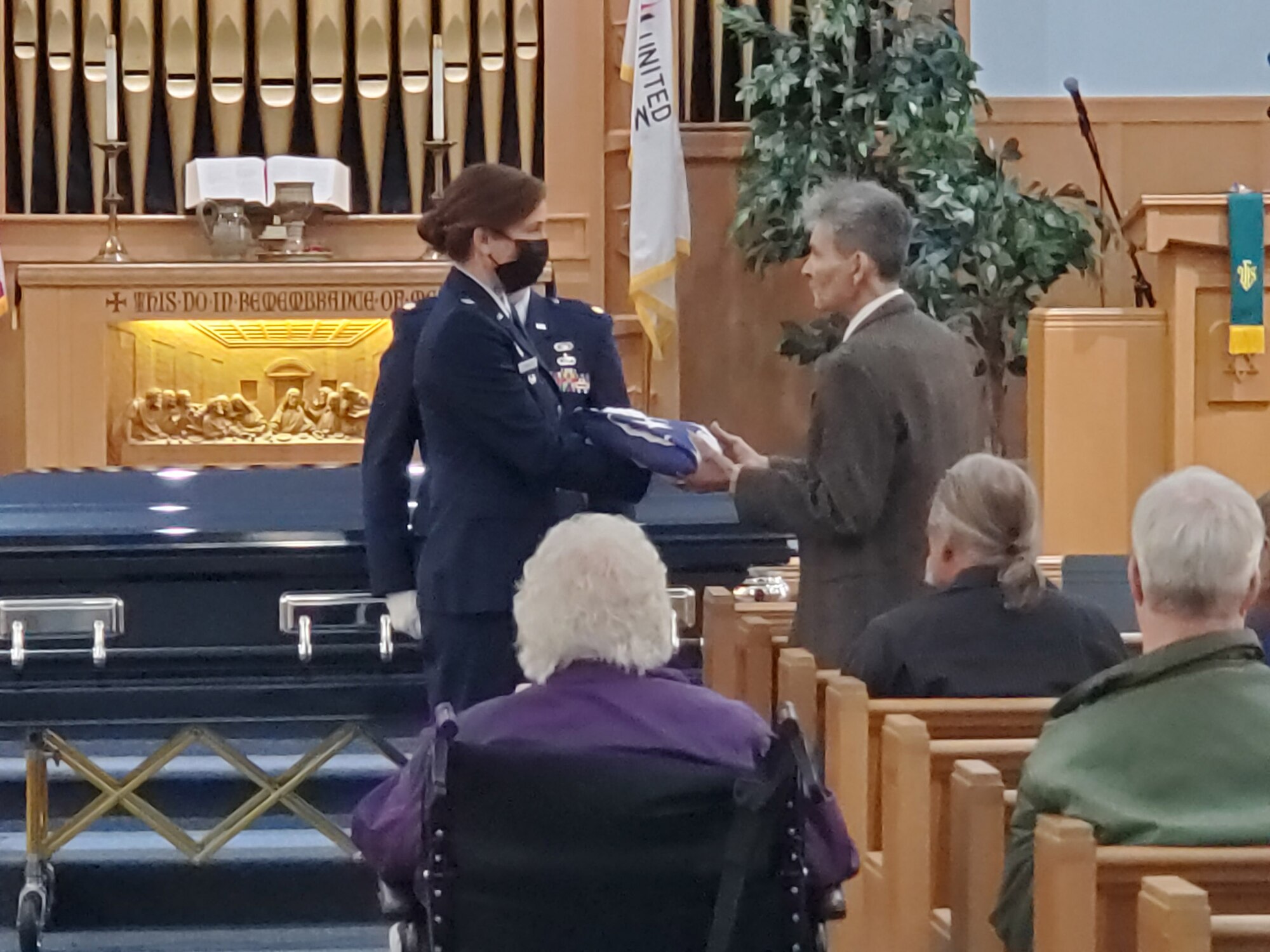 Lt. Col. (retired) Dianne Hickey, former 14th Intelligence Squadron commander, presents a flag to Tom, John “Jerry” Johnson’s beneficiary, during Johnson’s funeral service Oct. 23, 2021.  Hickey, along with current 14 IS reservists Maj. Andrew Soine and Senior Master Sgt. Jonathon Washington, conducted the funeral honors. Johnson had served in Guam during World War II with the Army Air Corps in the 20th Air Force 9th Photographic Technical Squadron. His squadron ultimately became the 14 IS.