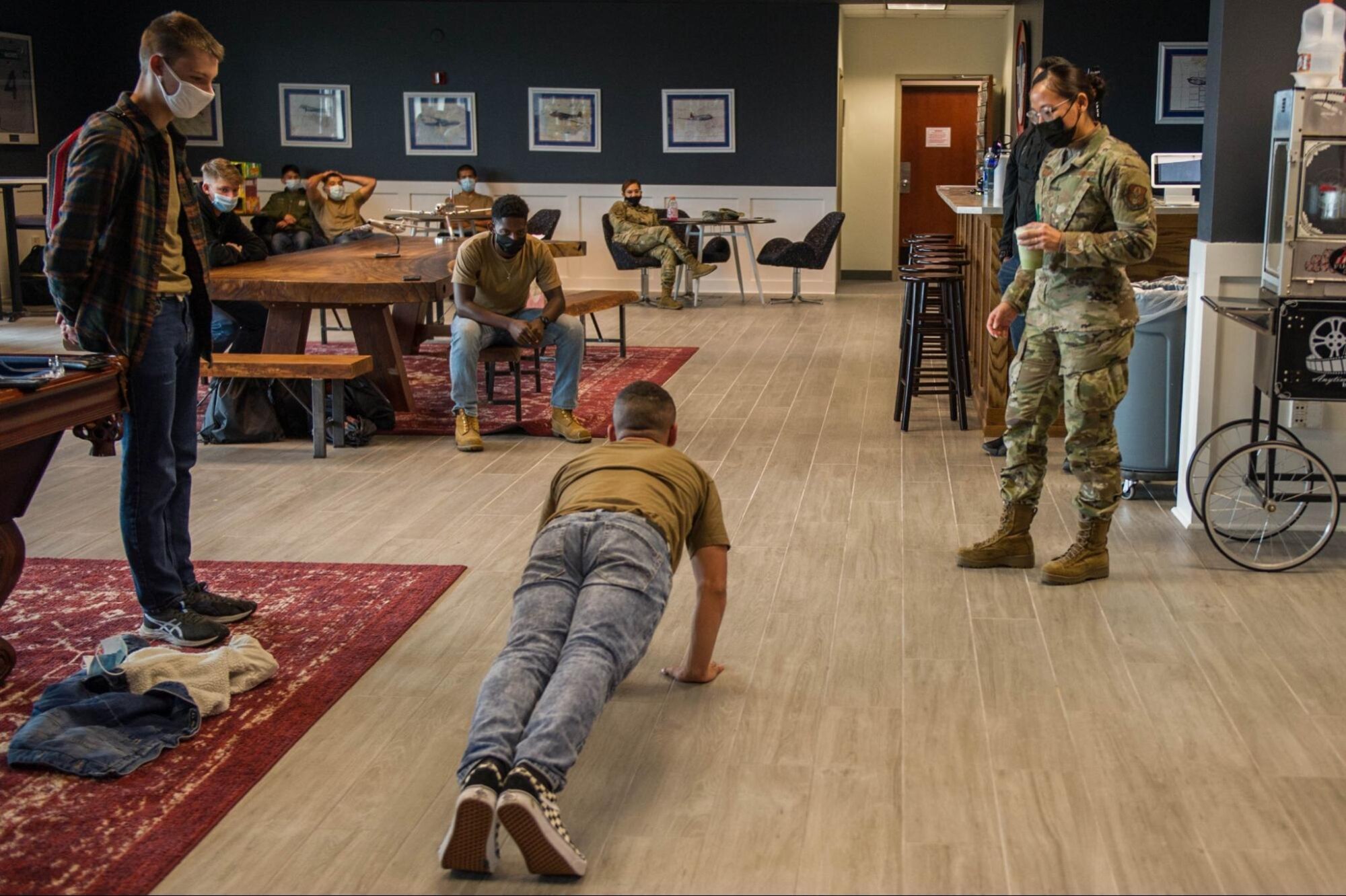 Trainee performs push-ups while others watch.