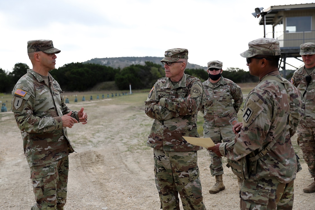 Command Sgt. Maj. Gilbert Garrett, left, command sergeant major for the 2nd Battalion, 337 Regiment, based out of Waterford, Michigan, briefs Command Sgt. Maj. Steven Slee, center, command sergeant major for the 85th U.S. Army Reserve Support Command, on his battalion’s mission during their mobilization at Fort Hood, Texas, October 20, 2021.