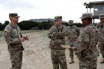 Command Sgt. Maj. Gilbert Garrett, left, command sergeant major for the 2nd Battalion, 337 Regiment, based out of Waterford, Michigan, briefs Command Sgt. Maj. Steven Slee, center, command sergeant major for the 85th U.S. Army Reserve Support Command, on his battalion’s mission during their mobilization at Fort Hood, Texas, October 20, 2021.