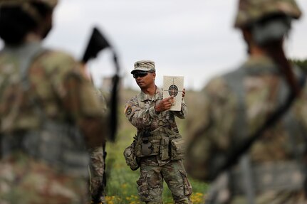 Staff Sgt. Joel Glewen, observer coach/trainer from the 2nd Battalion, 337 Regiment, based out of Waterford, Michigan, explains to Army Reserve Soldiers how to obtain a good grouping on the M4 carbine, and discusses the thresholds that are now required within the target circle.