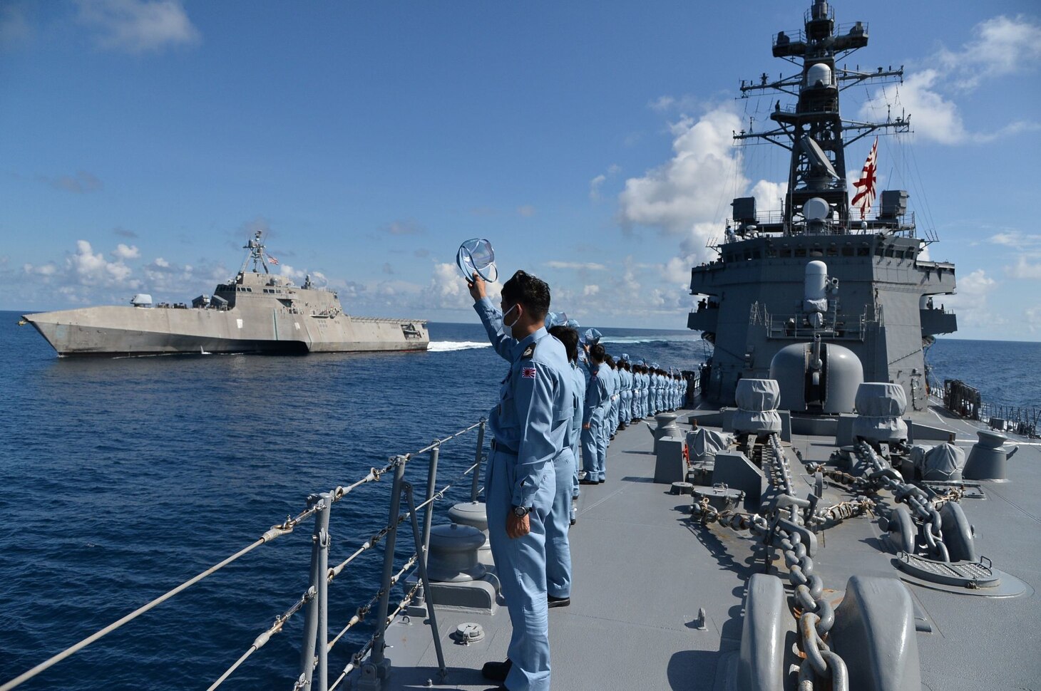 Sailors aboard Japan Maritime Self-Defense Force Murasame-class destroyer JS Yudachi (DD 103) wave to Independence-variant littoral combat ship USS Jackson (LCS 6) while sailing together in the South China Sea. Jackson, part of Destroyer Squadron Seven, are on a rotational deployment in the U.S. 7th Fleet area of operation to enhance interoperability with partners and serve as a ready-response force in support of a free and open Indo-Pacific region.