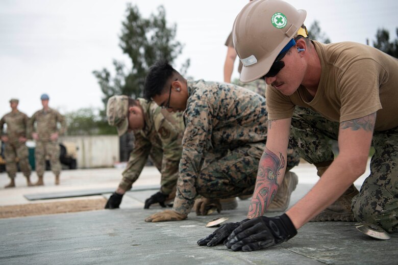 USAF, USMC, USN conduct repairs together.