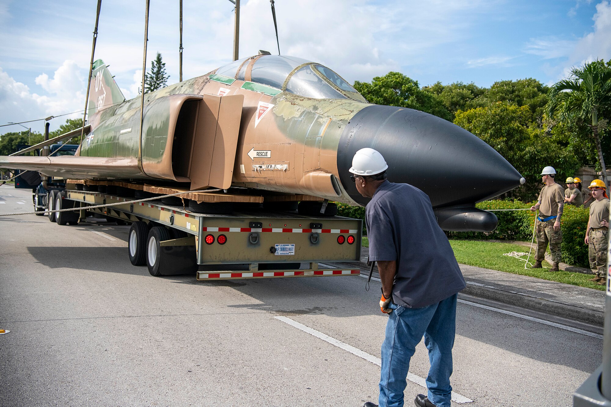 Mr. Melvin Miller, Phoenix Maintenance Incorporated transportation specialist, oversees the loading of F-4D fighter jet, serial number 66-0267, to a flatbed trailer prior to being transported to the aircraft corrosion control facility at Homestead Air Reserve Base, Fla., on Oct. 28, 2021 (U.S. Air Force photo by Tim Norton)