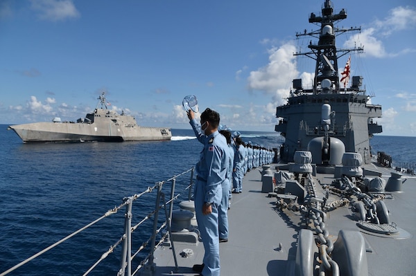 Sailors aboardJS Yudachi (DD 103) render honors to USS Jackson (LCS 6) during a transit of the South China Sea.