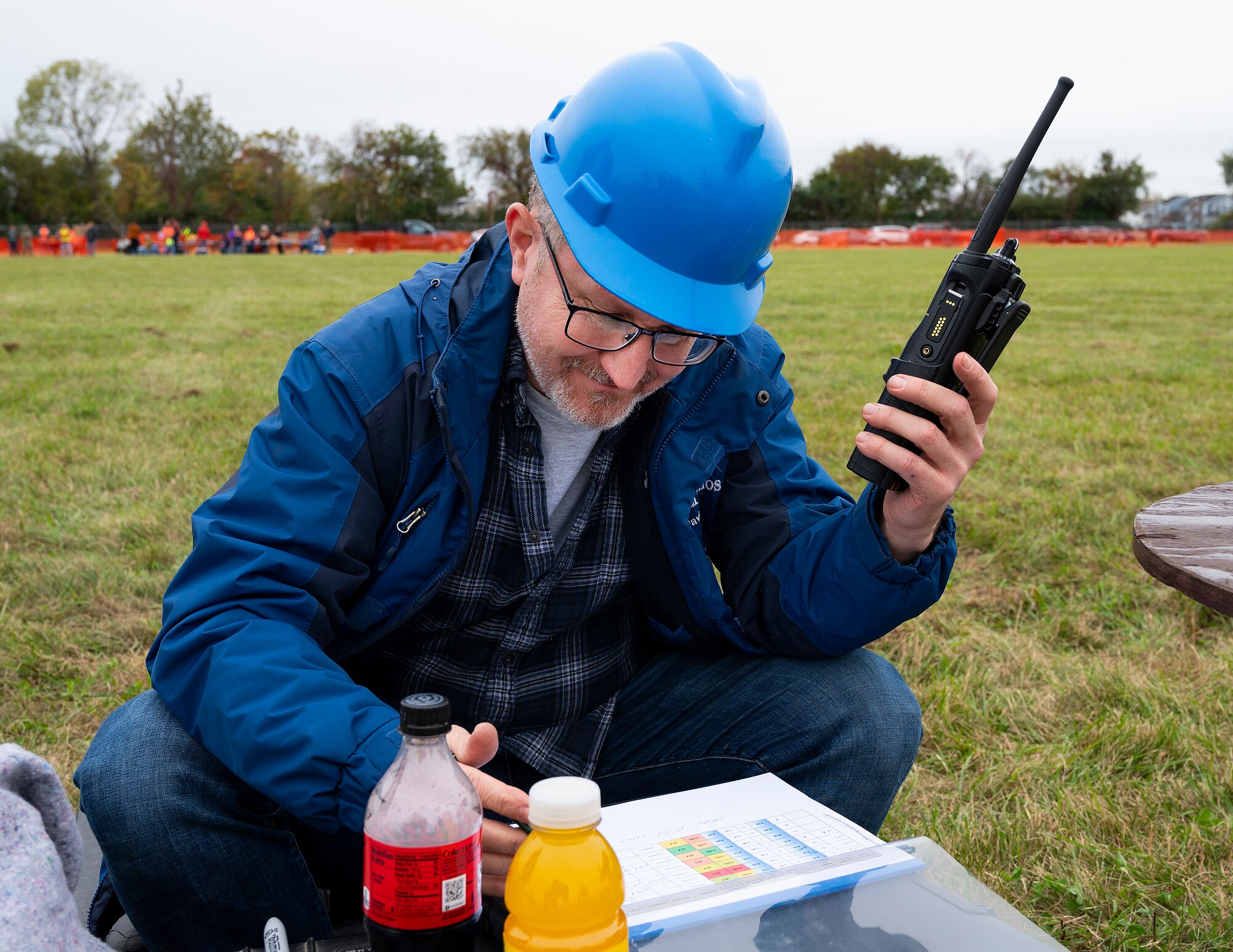 David Mollenhauer, Air Force Research Laboratory, monitors the radio as he waits for the results of one of his team’s chucks Oct. 22, 2021, at Wright-Patterson Air Force Base’s 16th Annual Pumpkin Chuck. With the pumpkins landing more than a half-mile from their starting point, radios were the only effective means of keeping track. (U.S. Air Force photo by R.J. Oriez)