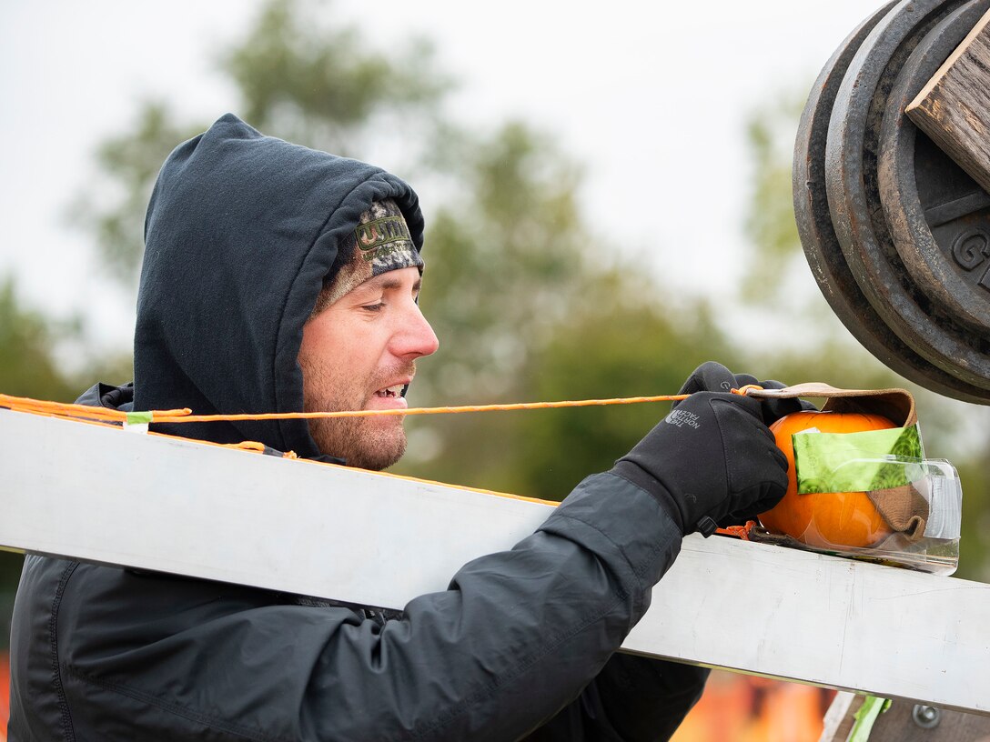 Aaron Makin places a pumpkin in his catapult’s sling Oct. 22, 2021, at Wright-Patterson Air Force Base’s 16th Annual Pumpkin Chuck. Makin’s team, Just Send It, got off to a rocky start as its first two attempts went backward; however, its third, and final, attempt went 450 feet for the Class B win. (U.S. Air Force photo by R.J. Oriez)