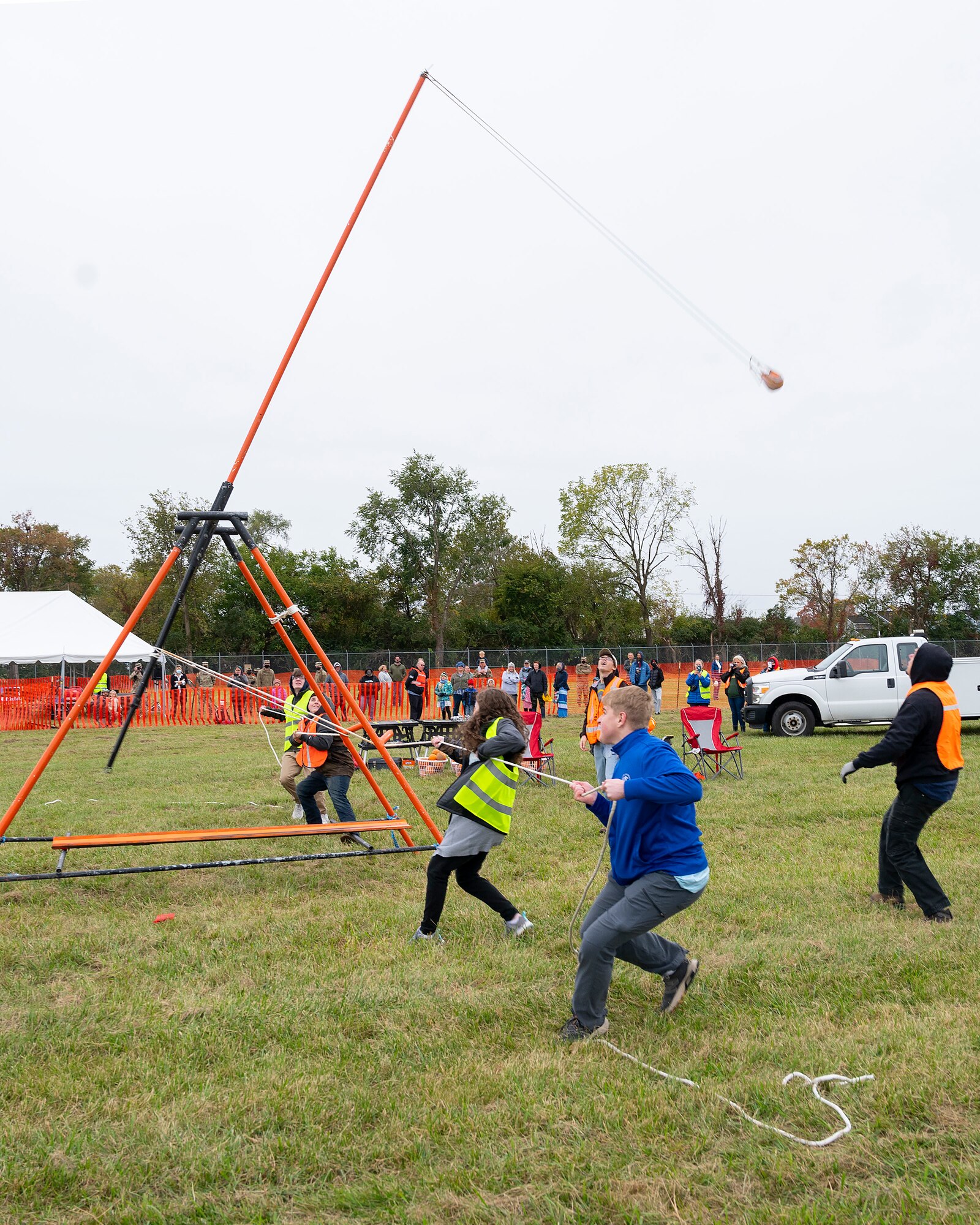 A team participates in the human-powered Class C category Oct. 22, 2021, at Wright-Patterson Air Force Base’s 16th Annual Pumpkin Chuck. Four competitors would pull on the ropes of a catapult to send a gourd toward a target several hundred feet downrange. (U.S. Air Force photo by R.J. Oriez)