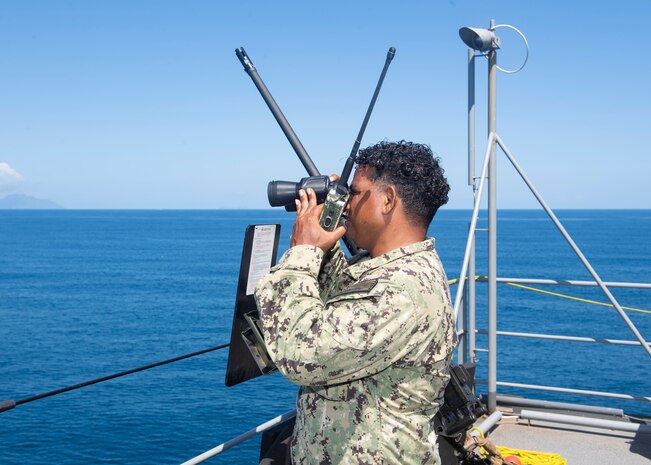 VICTORIA, Seychelles (Oct. 29, 2021) Machinist's Mate 1st Class Jhairo Pereyra stands watch aboard the Expeditionary Sea Base USS Hershel "Woody" Williams (ESB 4) as the ship pulls into port in Victoria, Seychelles, Oct. 29, 2021. Hershel "Woody" Williams is on a scheduled deployment in the U.S. Sixth Fleet area of operations in support of U.S. national security interests in Europe and Africa.