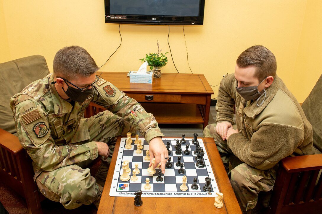 Airman 1st Class Charles Unruh, 28th Logistics Readiness Squadron distribution section chief, left, teaches Airman 1st Class Jonah Fronk, 28th Bomb Wing Staff public affairs journeyman how to play chess on Ellsworth Air Force Base, S.D., Oct. 20, 2021. 28 Munitions Squadron supported Unruh’s professional chess ambitions by getting him into the 62nd Annual U.S. Armed Forces Open Chess Championship bracket, giving him the opportunity to win and represent Ellsworth. (U.S. Air Force photo by Airman 1st Class Quentin K. Marx)