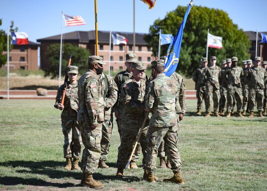 U.S. Army Lt. Col. Joseph Garwacki, 344th Military Intelligence Battalion commander, passes the colors to Command Sgt. Maj. Sudan Baker, incoming 344th MI BN command sergeant major during the 344th MI BN change of responsibility ceremony on Goodfellow Air Force Base, Texas Oct. 28, 2021. Through the passing of the colors, Garwacki transferred responsibility of the 344th MI BN as the senior enlisted leader to Baker. (U.S. Air Force photo by Staff Sgt. Tyrell Hall)