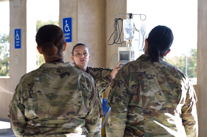 U.S. Air Force Capt. Jessica Nott (center), medical assistant, 316th Medical Group, speaks to the medical staff in the Malcolm Grow Medical Clinics and Surgery Center Fair at Joint Base Andrews, Md., Oct. 26, 2021.