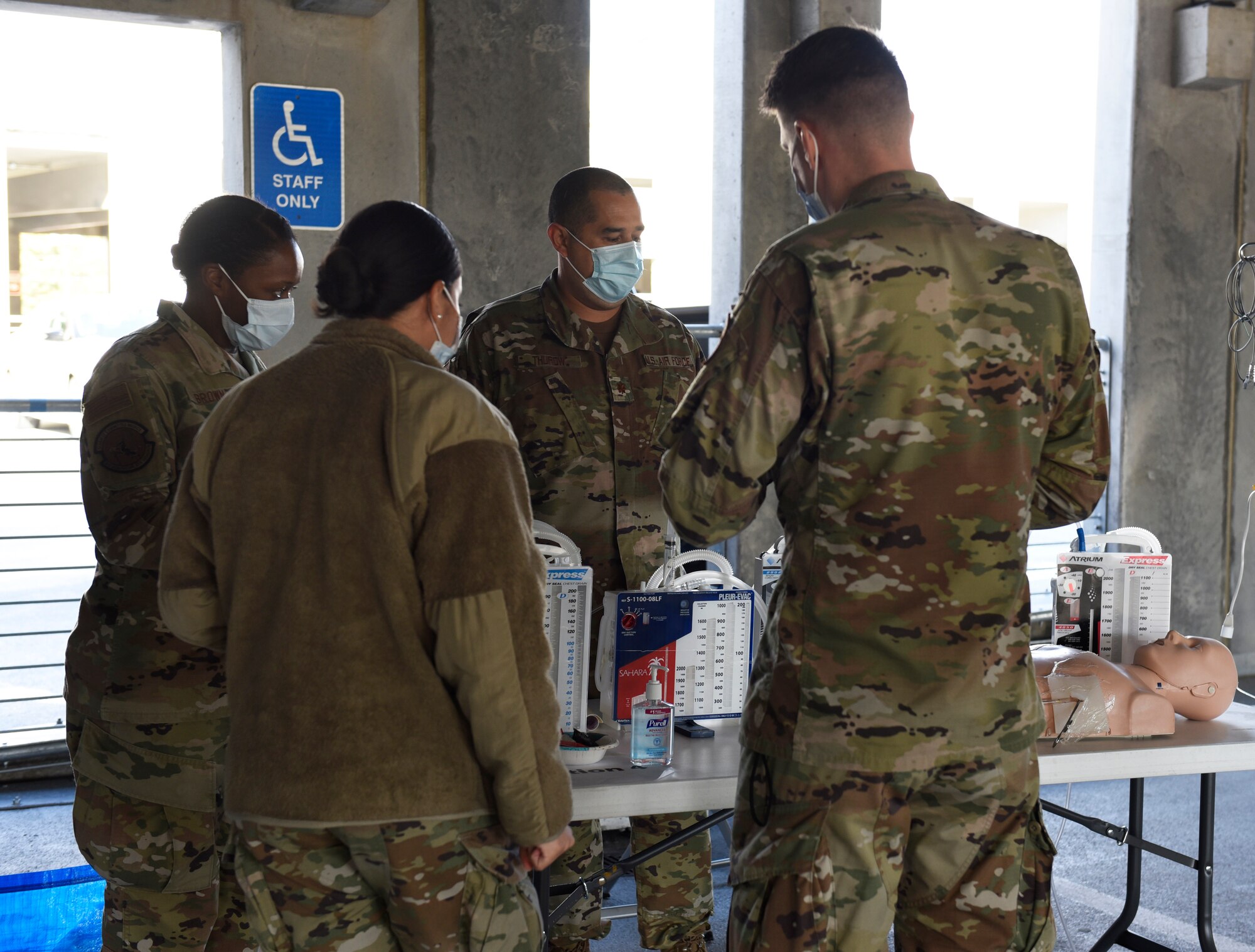 U.S. Air Force Maj. Daniel Thurow (center), 316th Healthcare Operations Squadron flight commander for the Air Force Element at Walter Reed National Military Medical Center, teaches Airmen about test tubes and other medical equipment at his station in the Malcolm Grow Medical Clinics and Surgery Center Fair, Joint Base Andrews, Md., Oct. 26, 2021.