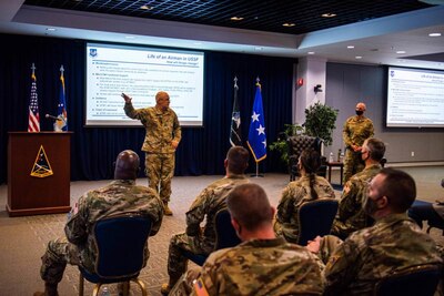 U.S. Air Force Gen. Arnold W. Bunch, Jr., Air Force Materiel Command, left, and U.S. Air Force Chief Master Sgt. David Flosi, AFMC command chief, speak to an audience of Airmen and Guardians during an All-Call at Los Angeles Air Force Base, California, Oct. 26, 2021. As the Servicing MAJCOM, AFMC will accomplish the roles and responsibilities traditionally performed by a Major Command for the Airmen supporting the U.S. Space Force. The Department of the Air Force created this unique and first-time serving MAJCOM structure to ensure Airmen assigned to the Space Force receive the same development opportunities, functional and administrative support as those as U.S. Air Force Installations. (U.S. Space Force photo by Staff Sgt. Luke Kitterman)