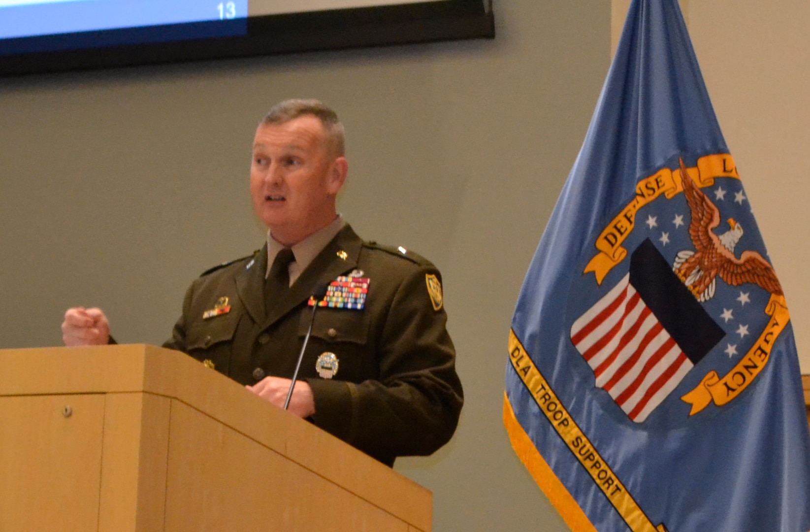 Army man talks at podium
