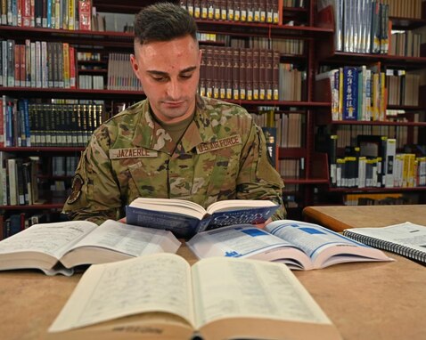 Airman 1st Class Omar Jazaerle reads an English to Arabic dictionary in the Aiso Library on Presidio of Monterey, CA., July 23, 2021. Jazaerle speaks five languages in total; English, French, Arabic, Spanish, and Korean. (U.S. Air Force photo by Senior Airman Michael Bowman)