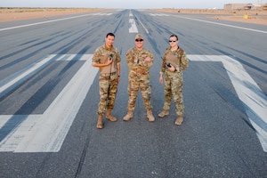 (L to R) Senior Airman Angel Maldonado, 2nd Lt. Anthony Charlonis and Senior Airman Rachel Zills, 409th Air Expeditionary Group, take a moment for a photo on the runway at Nigerien Air Base 201 in Agadez, Niger.