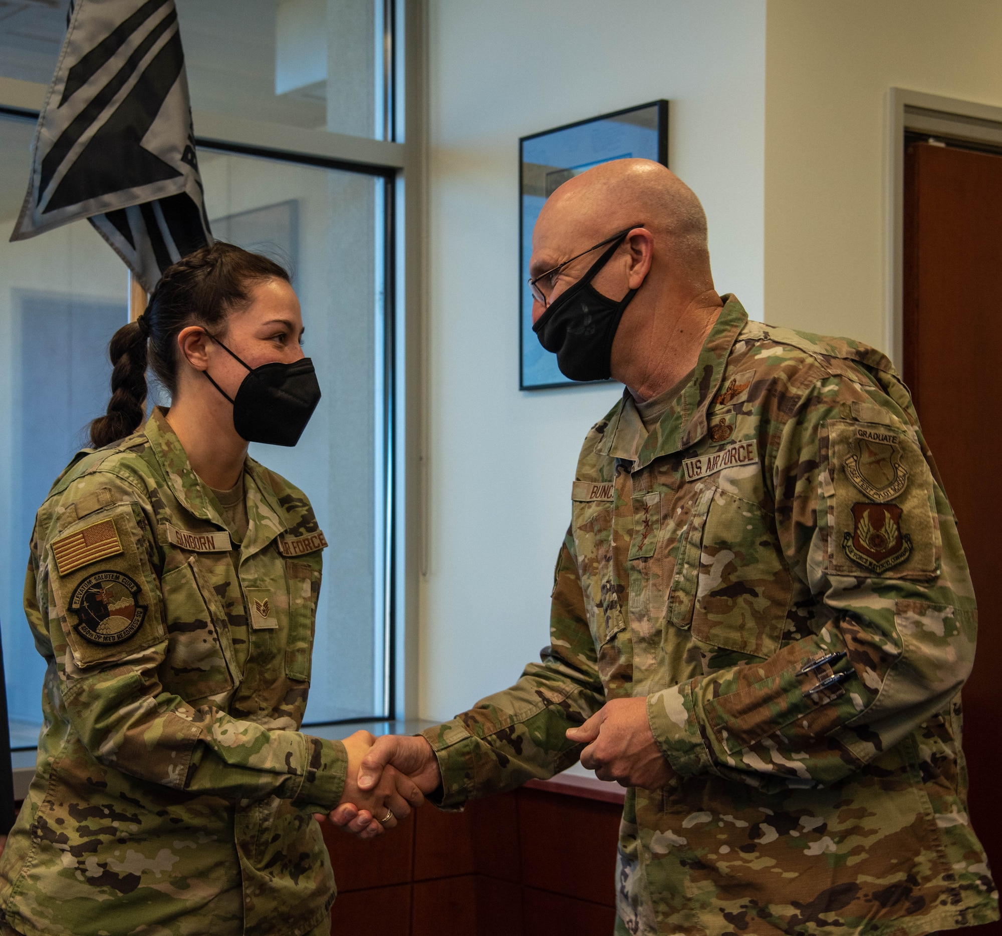 Gen. Arnold W. Bunch, Jr.,  Air Force Materiel Command commander coins Staff Sgt. Santana Sanborn, from the 460th Operational Medical Readiness Squadron, on Buckley Space Force Base, Colo., Oct. 28, 2021. Honoring someone with a coin is a Commander’s way to show appreciation for a phenomenal job. (U.S. Space Force photo by Airman 1st Class Shaun Combs)