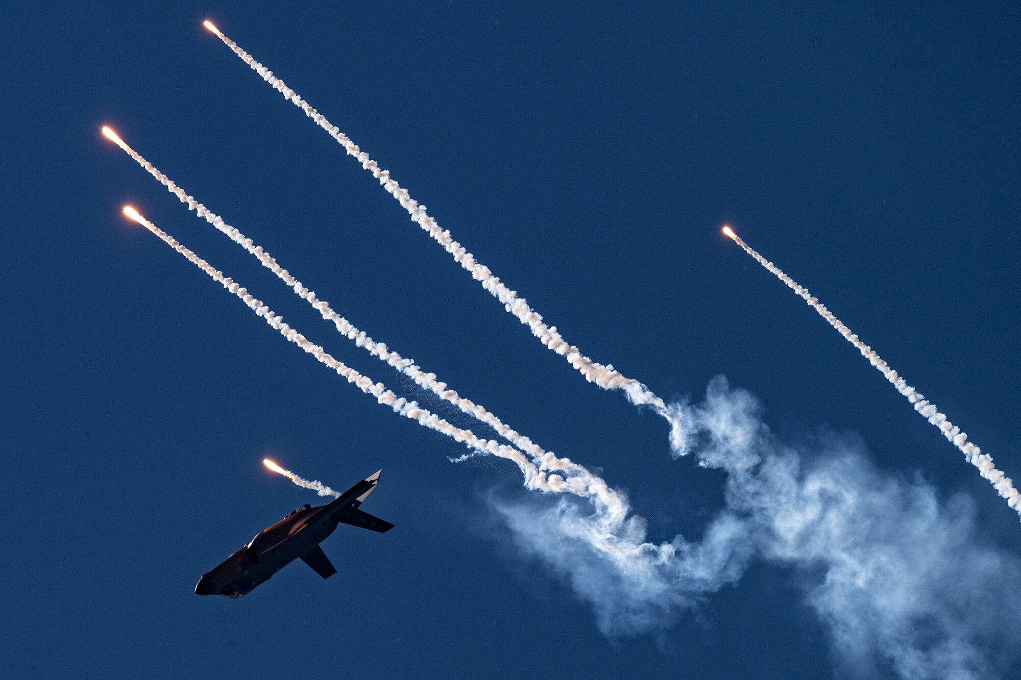 F-35A Lightning II deploys flares during aerial demonstration.