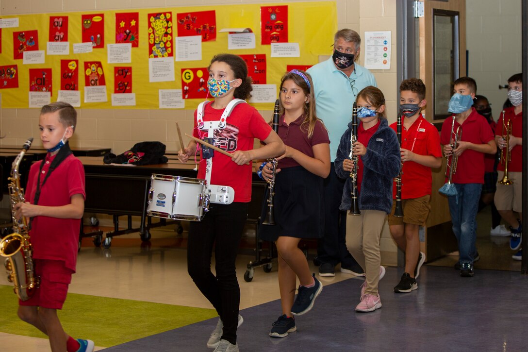 The Heroes Elementary School band marches into the auditorium at Heroes Elementary School on Marine Corps Base Camp Lejeune, North Carolina, Oct. 26, 2021.