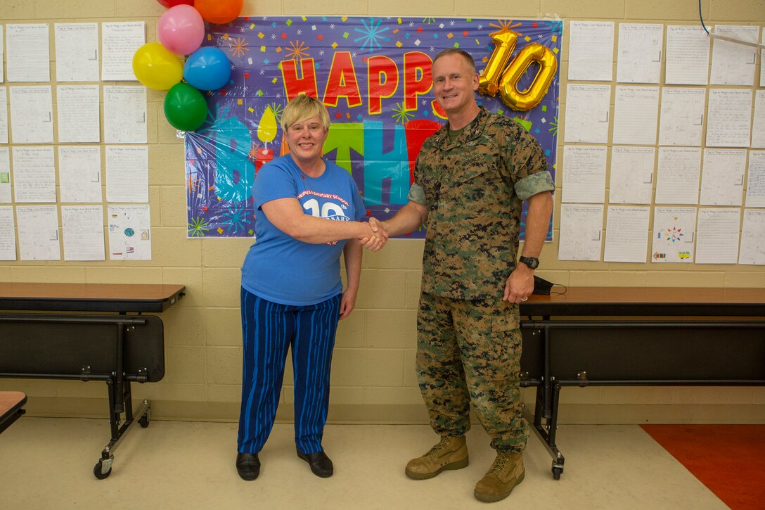 Dr. Kimberley Carr, left, the principal at Heroes Elementary School, stands with U.S. Marine Corps Col. Todd Ferry, right, the deputy commander for Marine Corps Installation East-Marine Corps Base Camp Lejeune, at Heroes Elementary School, on MCB Camp Lejeune, North Carolina, Oct. 26, 2021.