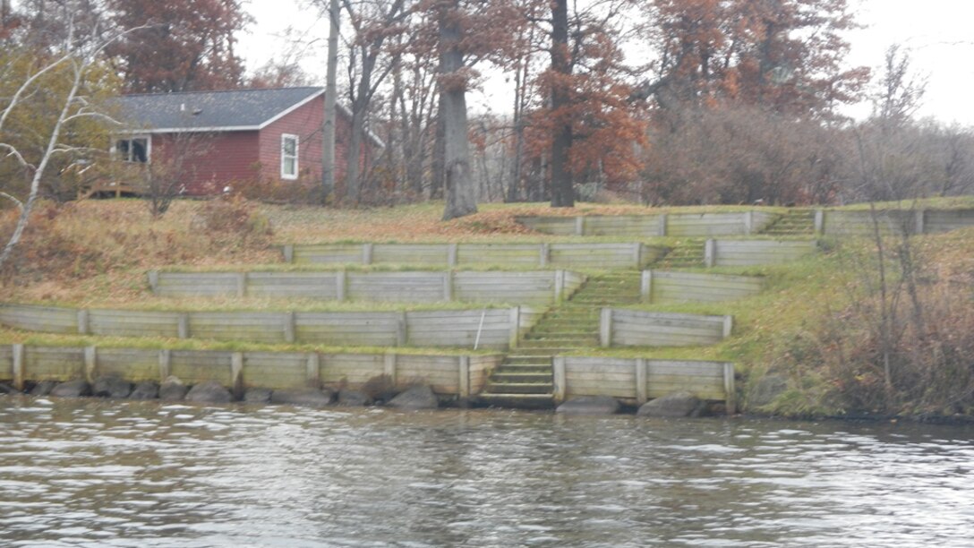 A lake with steps on the shoreline.