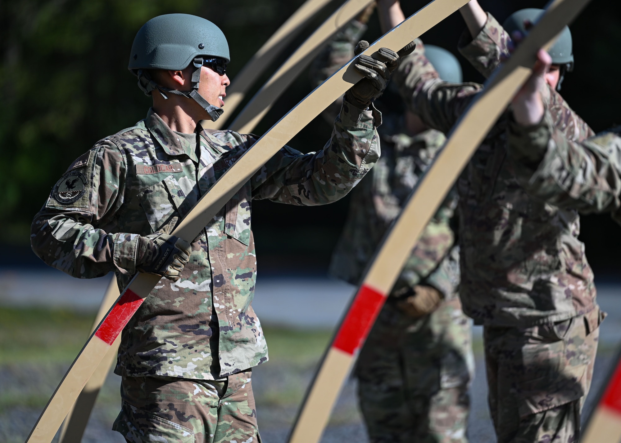 Airmen set up a military shelter system