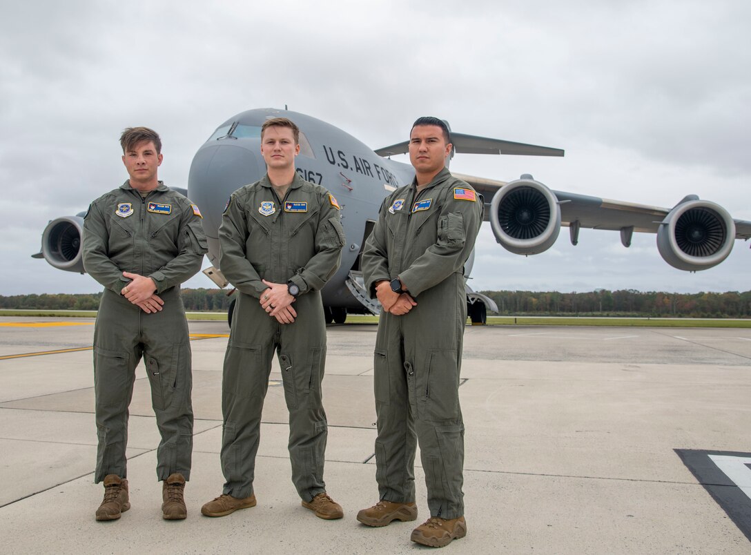 From the left, Senior Airman Allan Romanov, Staff Sgt. Timothy Bukovich and Senior Airman Vincent Leal, all 436th Security Forces Squadron Phoenix Raven team members, stand in front of a C-17 Globemaster III at Dover Air Force Base, Delaware, Oct. 29, 2021. The Ravens provided security to Air Mobility Command assets during Operation Allies Refuge, the largest non-combatant evacuation operation airlift in U.S. history, evacuating more than 124,000 people from Hamid Karazai International Airport, in Kabul, Afghanistan. (U.S. Air Force photo by Tech. Sgt. Nicole Leidholm)