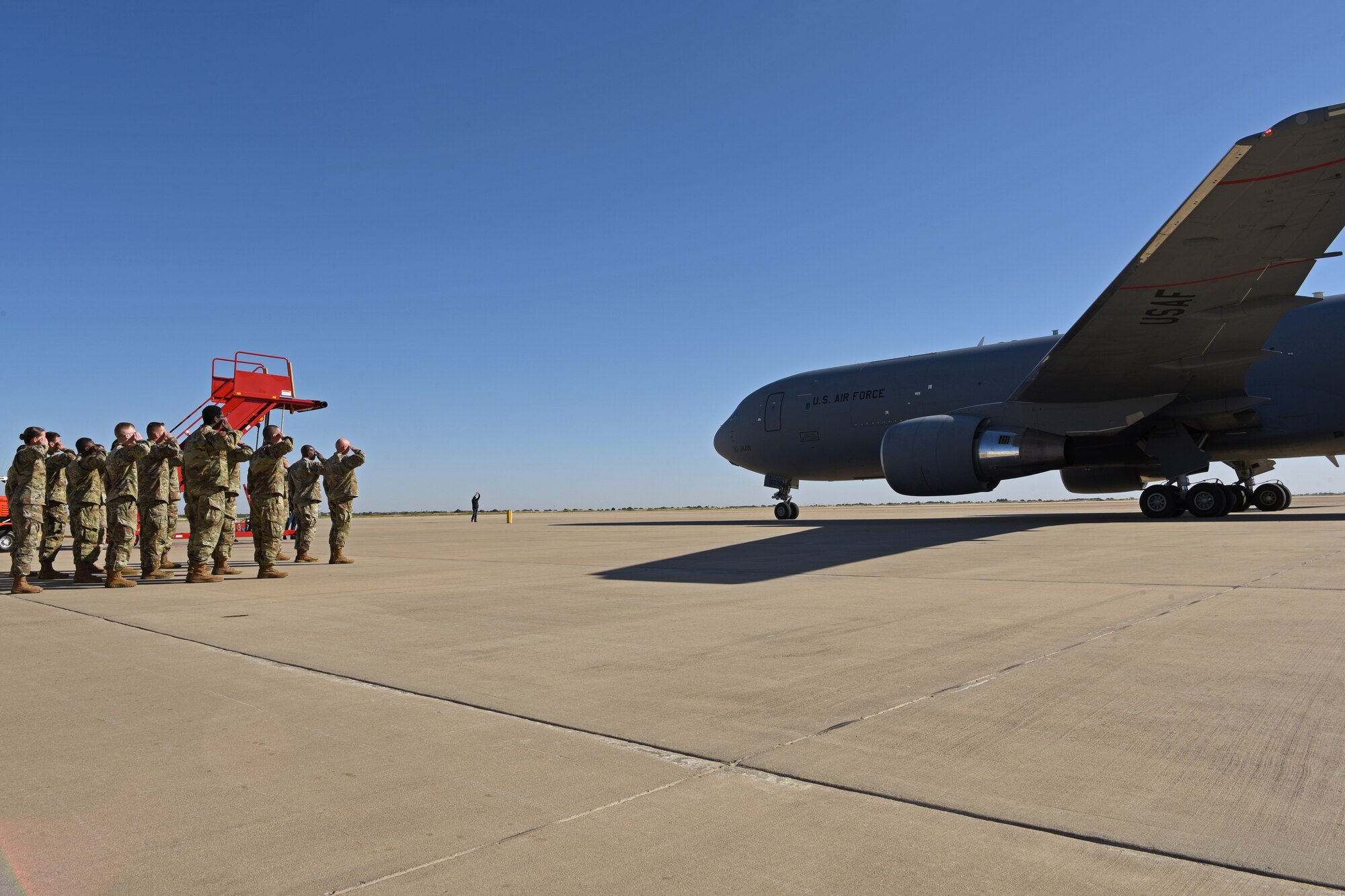U.S. Air Force Col. Matthew Reilman, 17th Training Wing commander, and members of the 17th Training Wing greet the arriving aircraft with a salute at the San Angelo Regional Airport, Texas, Oct. 27, 2021. The aircraft carried Maj. Gen. Andrea Tullos, Air Education and Training Command deputy commander, and AETC’s Civic Leader Program members. (U.S. Air Force photo by Senior Airman Abbey Rieves)