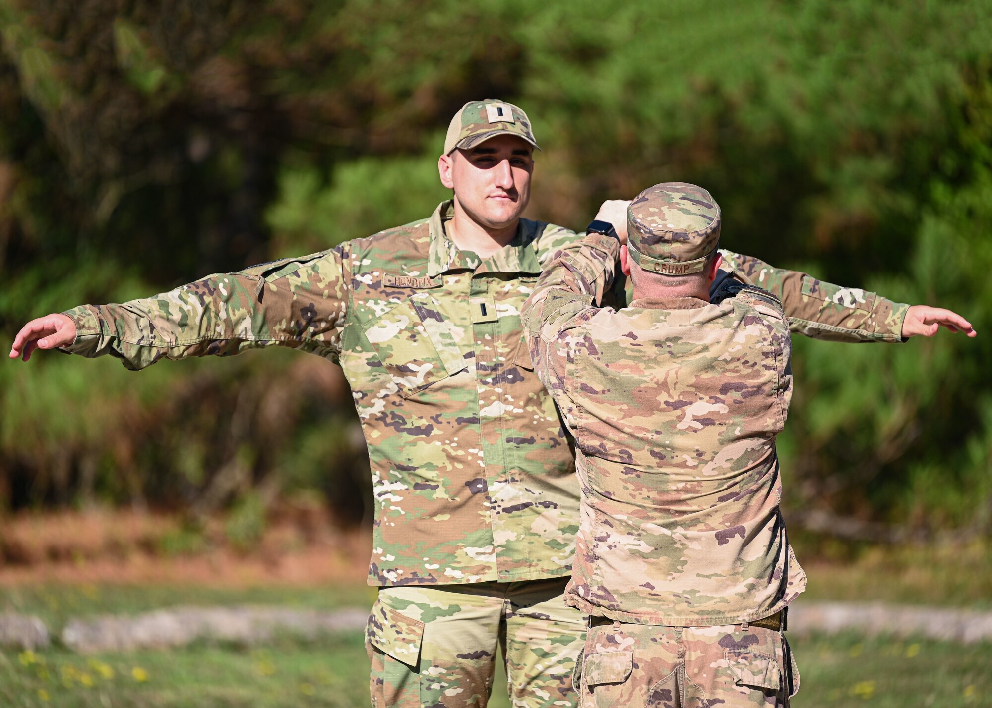 An Airman conducts a search of another Airman