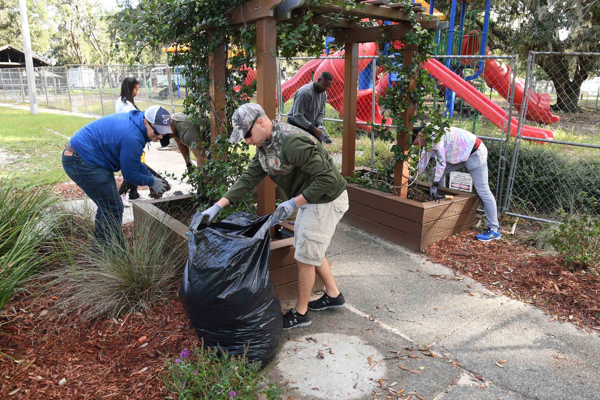 Members of the 81st Training Support Squadron participate in Base Cleanup Day at the marina park at Keesler Air Force Base, Mississippi, Oct. 29, 2021. Base leadership joined Airmen to clean up around the base to inspire beautification. (U.S. Air Force photo by Kemberly Groue)
