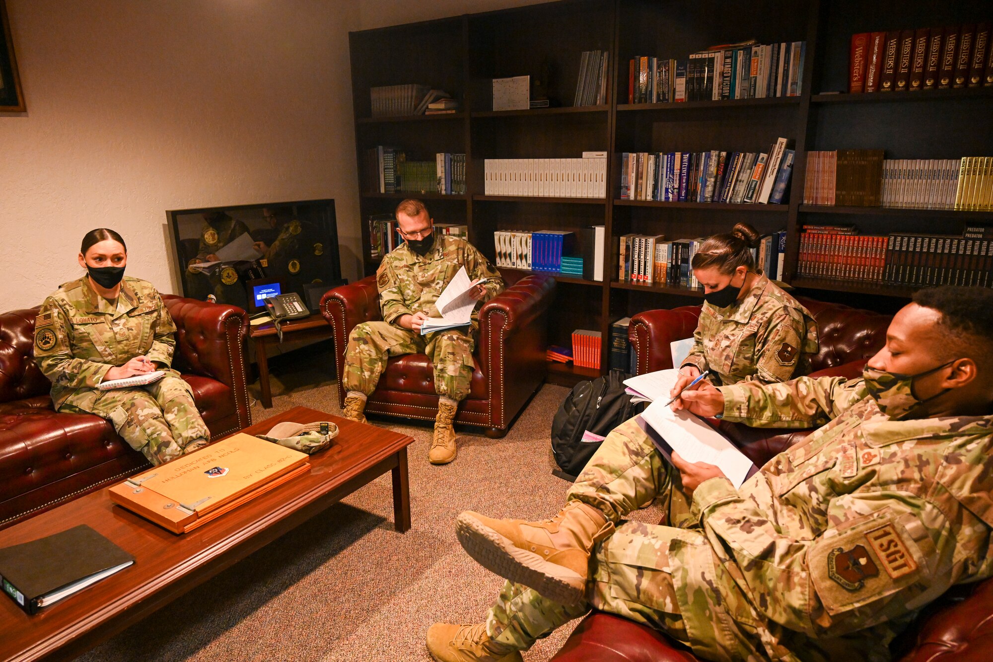 A senior enlisted member reviews a performance report at the Tech. Sgt. Records, Oct. 18, 2021, on Holloman Air Force Base, New Mexico. Technical sergeants broke out into groups with senior enlisted members to get direct feedback on their records. (U.S. Air Force photo by Airman 1st Class Adrian Salazar)