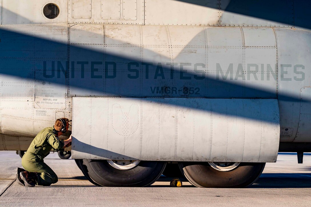 A Marine inspects an aircraft.