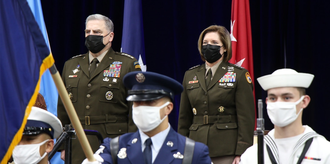 Members of the U.S. Southern Command Honor Guard present the colors while Chairman of the Joint Chiefs of Staff Gen. Mark A. Milley and U.S. Army Gen. Laura J. Richardson, incoming commander of U.S. Southern Command, stand at attention during a change of command ceremony at SOUTHCOM Headquarters in Doral, Florida, Oct. 29, 2021.