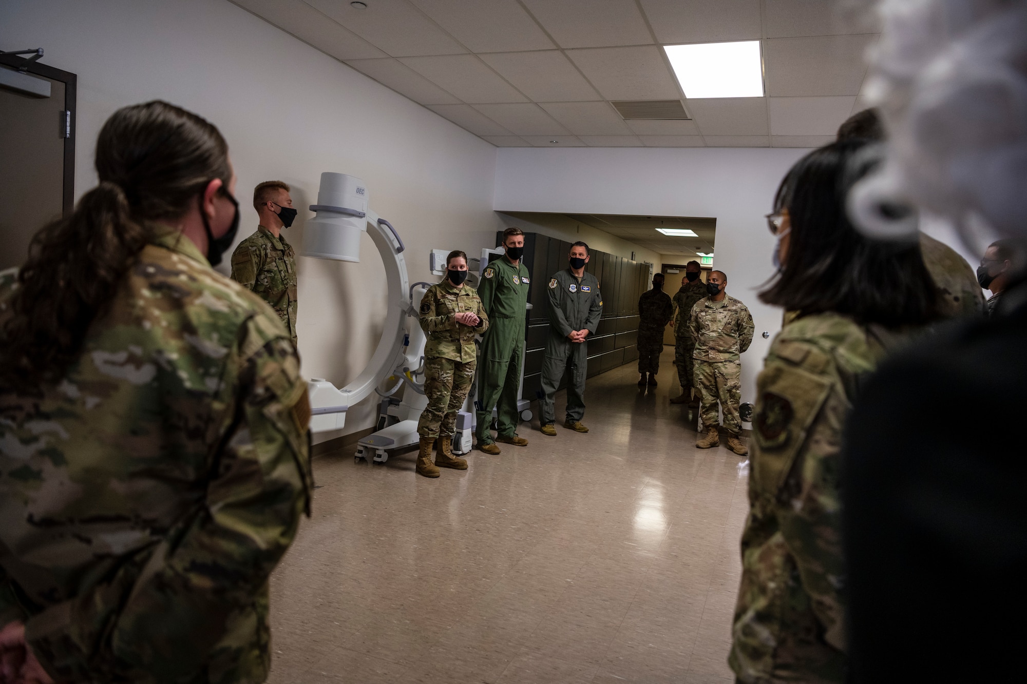 A room full of people in uniform meet.