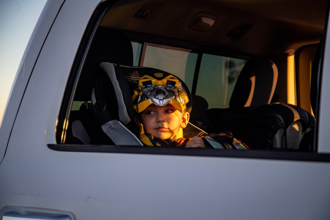 A child collects candy during the 7th Annual Red Ribbon Trunk or Treat at Marine Corps Air Station Yuma, Ariz., Oct. 28, 2021. The event created a fun and safe environment for Marines and their families to celebrate Halloween while promoting a drug free Marine Corps. (U.S. Marine Corps photo by Cpl. Gabrielle Sanders)