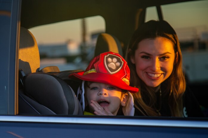 A child collects candy during the 7th Annual Red Ribbon Trunk or Treat at Marine Corps Air Station Yuma, Ariz., Oct. 28, 2021. The event created a fun and safe environment for Marines and their families to celebrate Halloween while promoting a drug free Marine Corps. (U.S. Marine Corps photo by Cpl. Gabrielle Sanders)