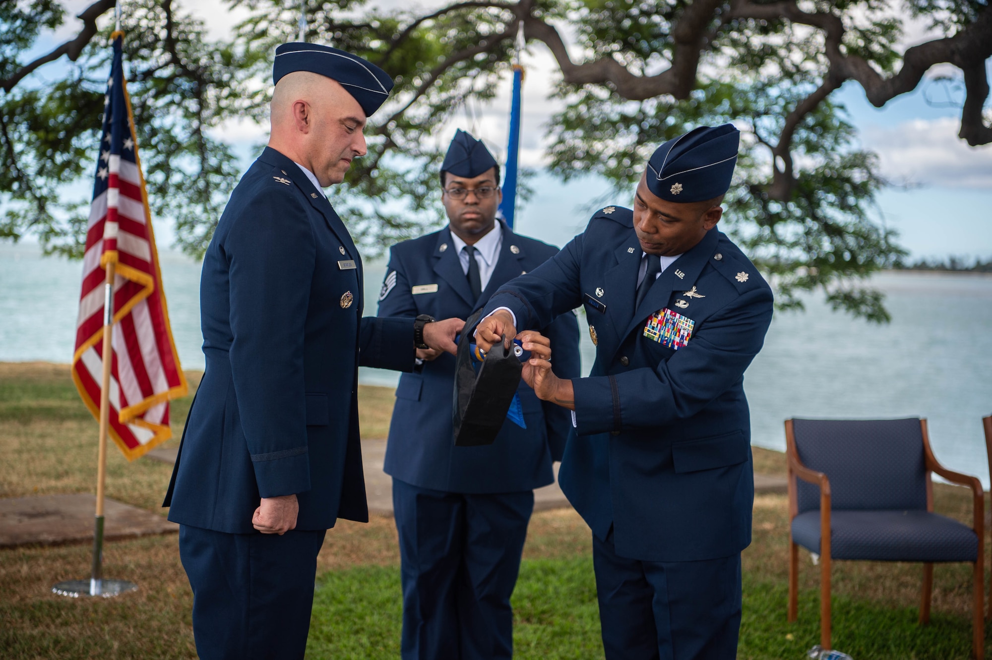 Col. Michael Staples, 647th Air Base Group commander and Joint Base Pearl Harbor-Hickam deputy commander, holds the 747th Communications Squadron guidon as Lt. Col. Michael Brewer, 747th Cyberspace Squadron commander, furls it during a redesignation ceremony at JBPHH, Hawaii, Oct. 29, 2021. The 747th CS was renamed to the 747th CYS, making it the Air Force’s first operational cyberspace squadron. (U.S. Air Force photo by Senior Airman Alan Ricker)