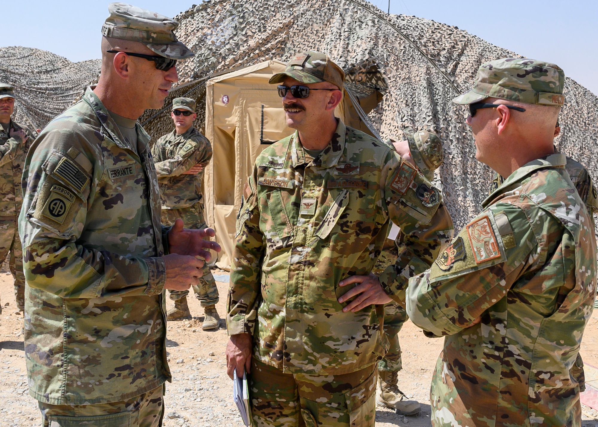 U.S. Army Sgt. Maj. John Ferrante Jr., U.S. Central Command forward senior enlisted leader in the Kingdom of Saudi Arabia, discusses the capabilities of U.S. personnel at Prince Sultan Air Base, KSA with U.S. Air Force Col. Kevin Davidson, 378th Air Expeditionary Wing vice commander, and Chief Master Sgt. Jackson Helzer, 378th AEW command chief, Oct. 12, 2021. Crimmins visited PSAB for the first time since assuming the SDO role in September, meeting with various personnel to learn about defense efforts and expanding capabilities on base. (U.S. Air Force photo by Senior Airman Samuel Earick)