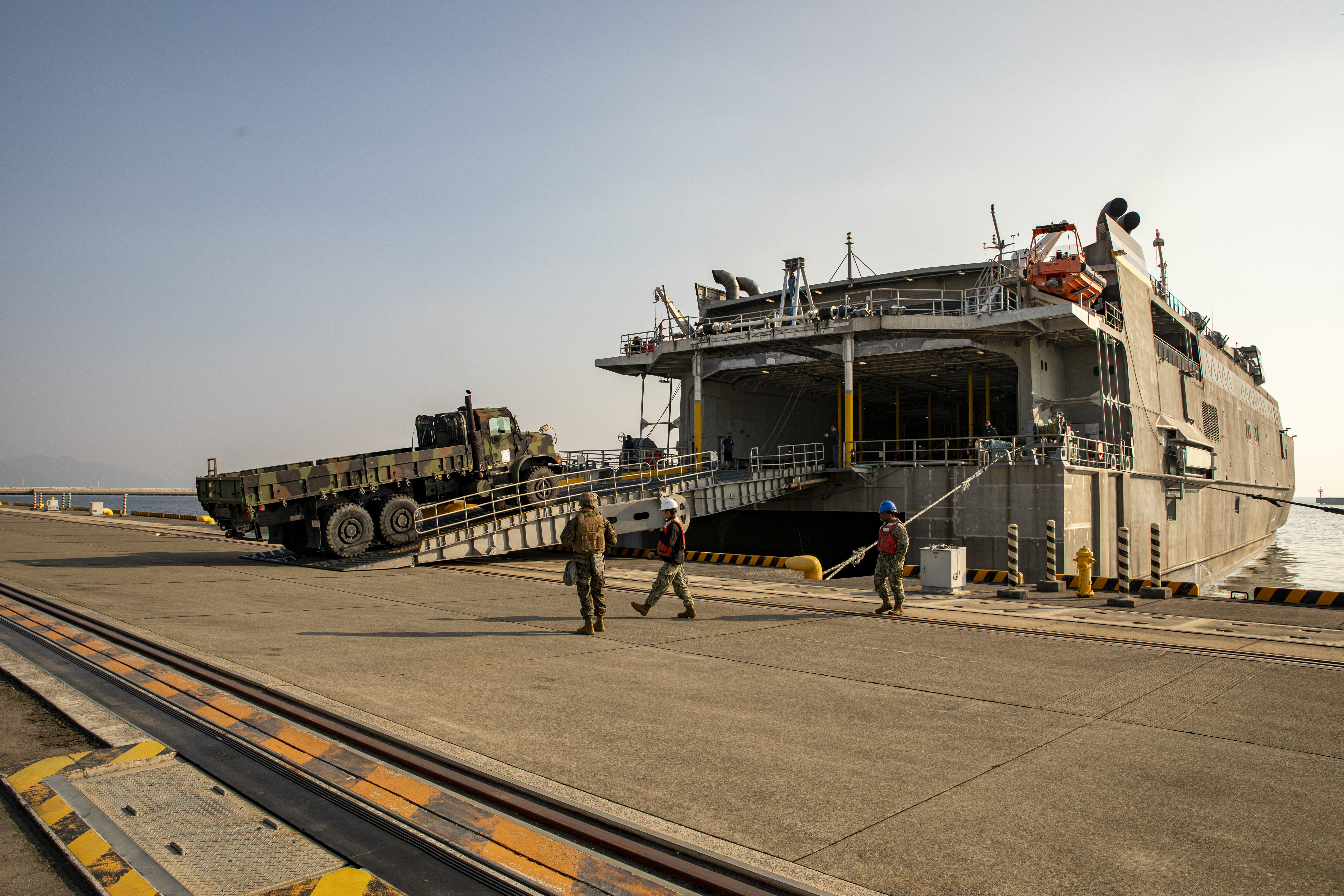 A seven ton truck drives aboard USNS Guam (T-HST-1) during Exercise Active Shield at Marine Corps Air Station Iwakuni, Japan, Oct. 28, 2021.