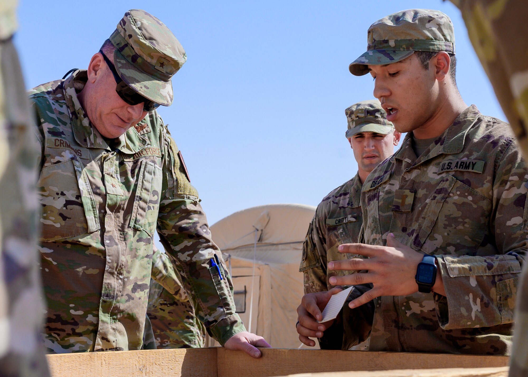 U.S. Army 2nd Lt. Erik Del Cid, an Air Defense Artillery member deployed to Prince Sultan Air Base, Kingdom of Saudi Arabia, discusses the defense of U.S. forces at PSAB to U.S. Air Force Brig. Gen. Thomas Crimmins, Senior Defense Official and Defense Attaché at the Embassy of the United States, KSA, during a base tour, Oct. 12, 2021. Crimmins visited the base for the first time since assuming the SDO role in September, meeting with various personnel to learn about defense efforts and expanding capabilities on base. (U.S. Air Force photo by Senior Airman Samuel Earick)