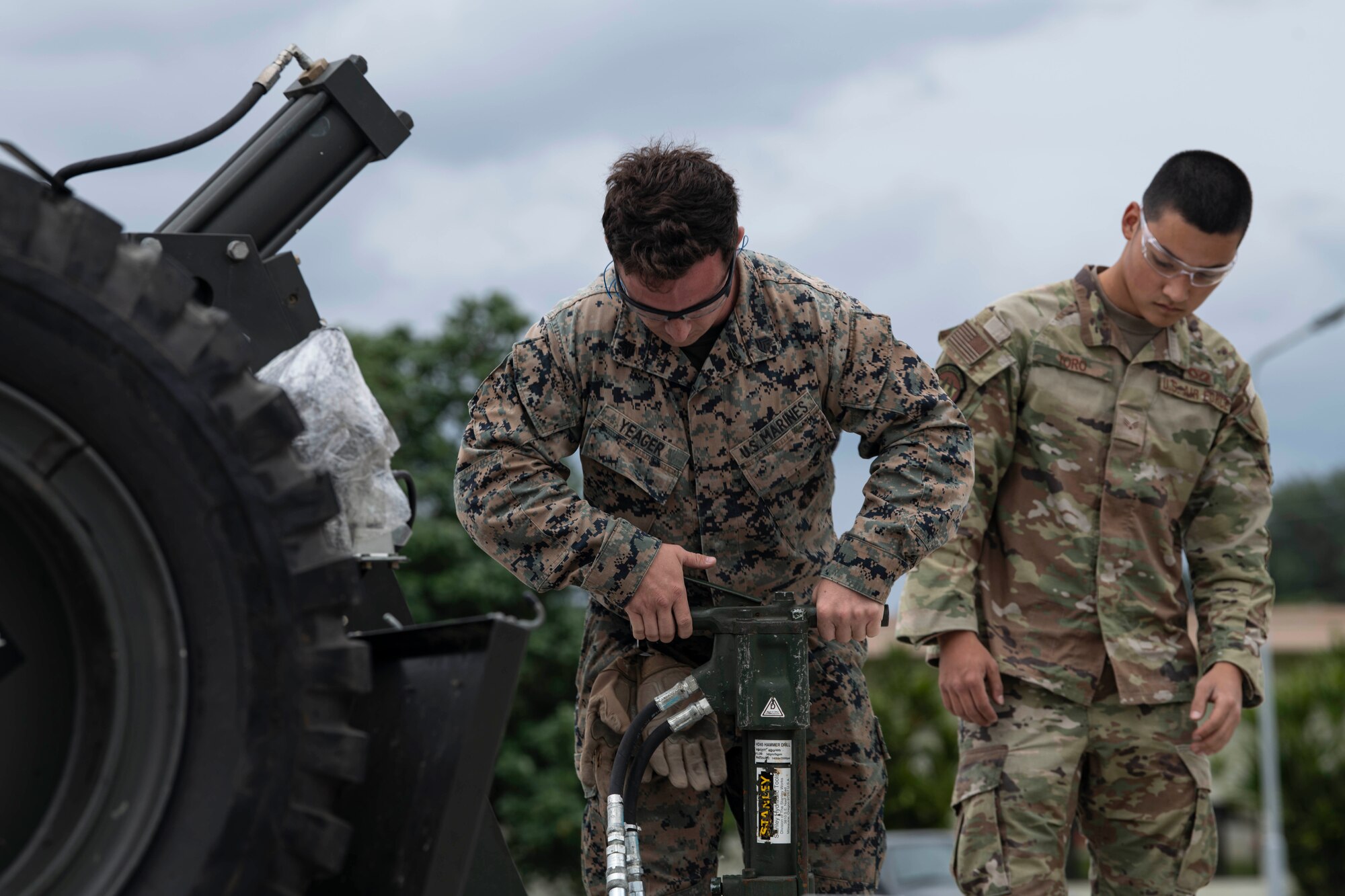 USAF and USMC members operate equipment together.