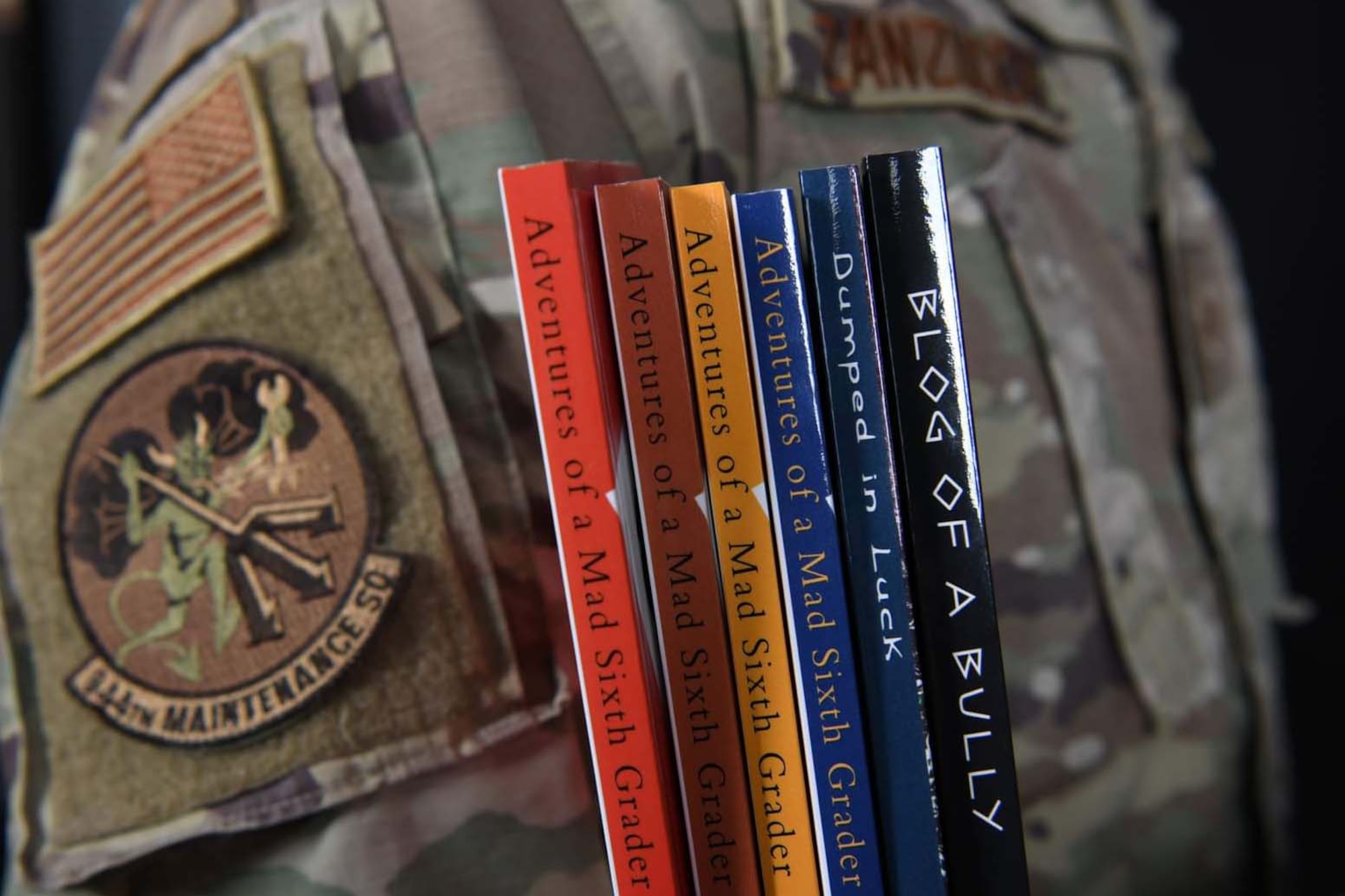 Luke Air Force Base, Ariz. -- Reserve Citizen Airman Staff Sgt. Stephen Zanzucchi, 944th Maintenance Squadron munitions support equipment maintenance crew chief, poses for a photo at Luke Air Force Base, Ariz., October 5, 2021. Zanzucchi was informed by his students that they didn’t want to read the books they had because they were boring so he chose to write them new ones. (U.S. Air Force photo/Master Sgt. Courtney Richardson)