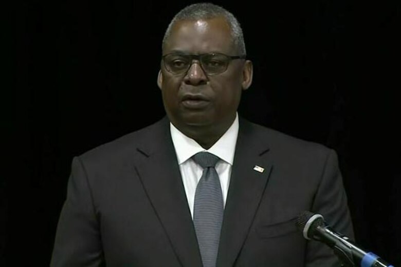 A man speaks during a ceremony.