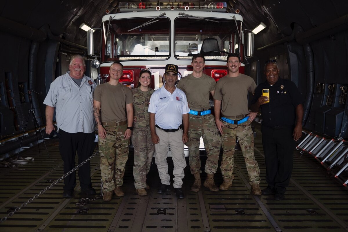 U.S. Airmen assigned to the 60th Air Mobility Wing take a photo with fire chiefs from the Dominican Republic at San Isidro Air Base, Dominican Republic, Oct. 28, 2021. Through the Denton Program, the 60th AMW aircrew transported more than 56,000 pounds of firefighting supplies in an effort to modernize Dominican fire response and rescue capabilities.