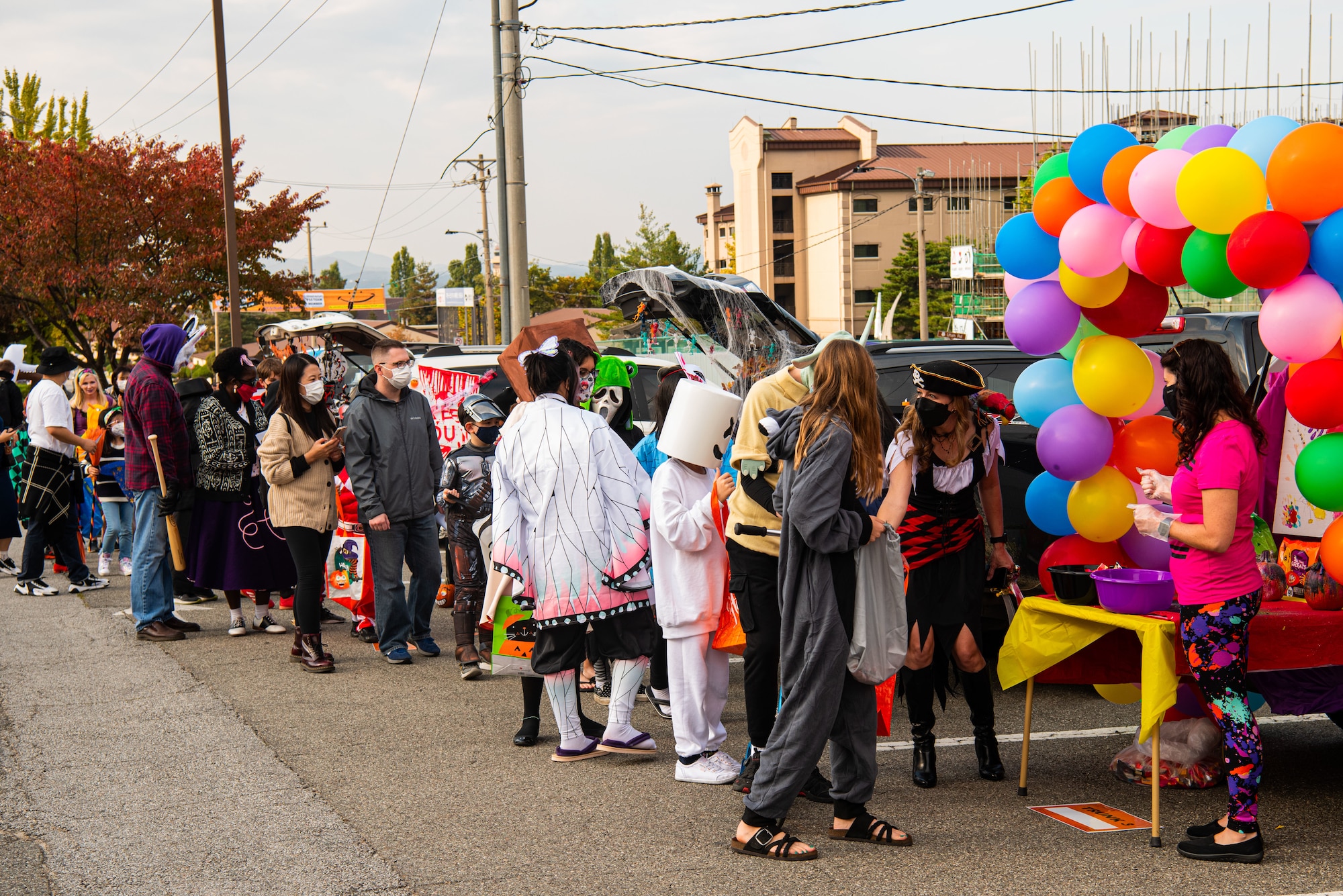 Families line up and wait to enter the Fall Festival & Trunk or Treat event hosted by the 51st Force Support Squadron Oct. 30, 2021, at Osan Air Base, Republic of Korea.