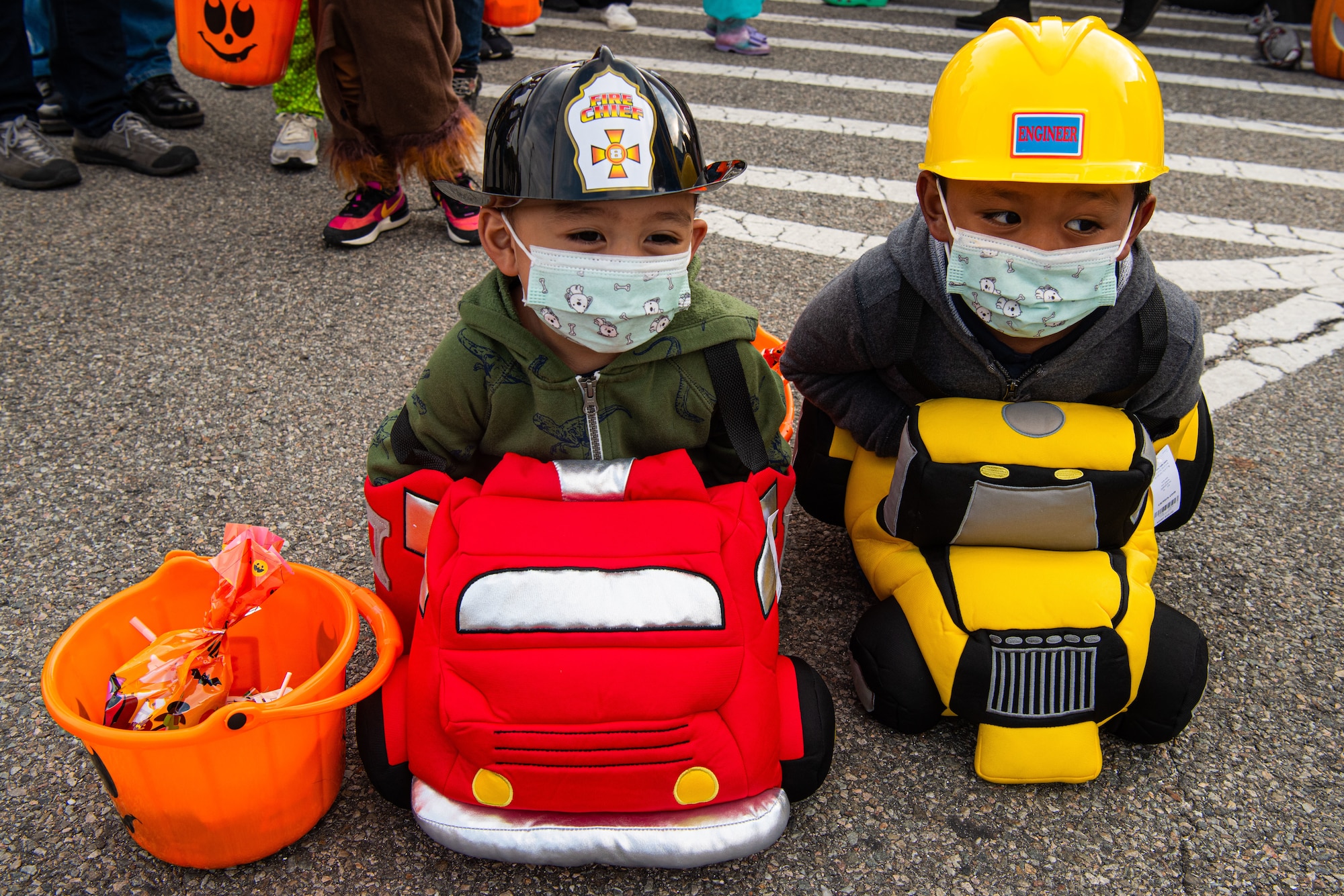 Children attending the Fall Festival & Trunk or Treat event hosted by the 51st Force Support Squadron smile at those passing by Oct. 30, 2021, at Osan Air Base, Republic of Korea.